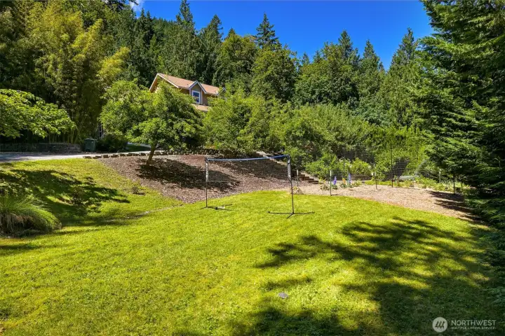 The lower lawn provides additional usable outdoor space adjacent to the orchard, berry gardens, and vegetable beds. Whether it's a soccer game, lawn games, pets, or simply room to spread out, this area adds another layer of functionality to the property's landscape. The lower lawn provides additional usable outdoor space adjacent to the orchard, berry gardens, and vegetable beds. Whether it's a soccer game, lawn games, pets, or simply room to spread out, this area adds another layer of functionality to the property's landscape.