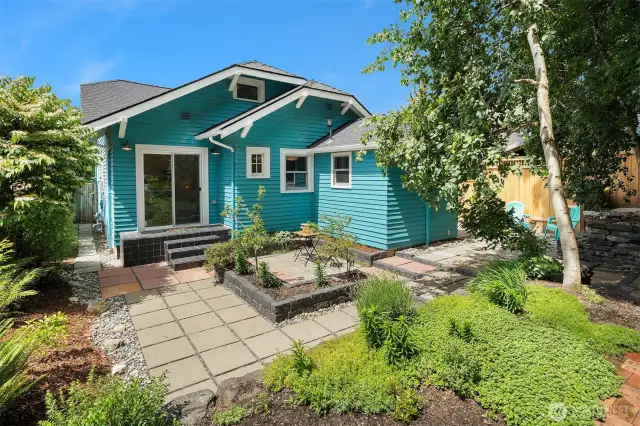Sunny outdoor space with patio and mature landscaping