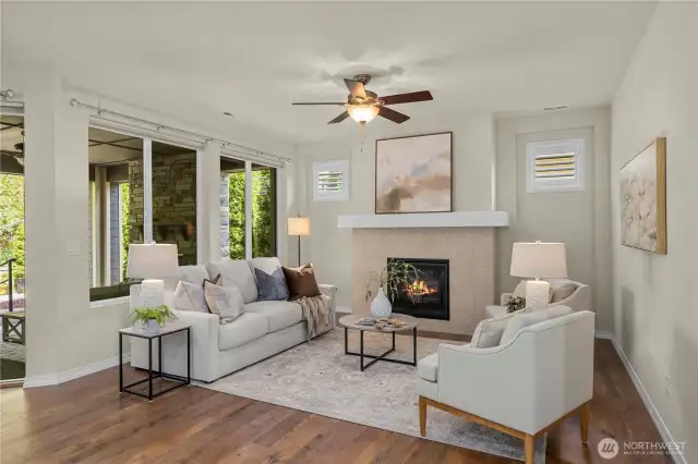 The spacious great room offers a sleek, tiled fireplace and huge picture windows overlooking the breathtaking back yard. Shutters in the windows above the fireplace and top down/bottom up in the large windows.