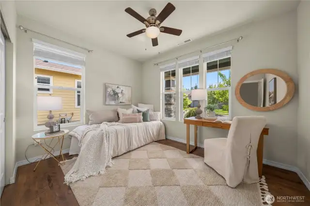 Spacious second bedroom overlooks the wide front porch.  Ceiling fan and blinds.