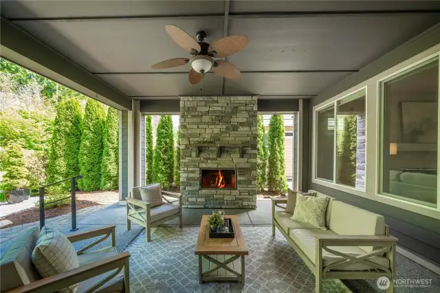 The stunning stone fireplace creates a lovely and inviting ambiance while overlooking the private and delightful backyard.