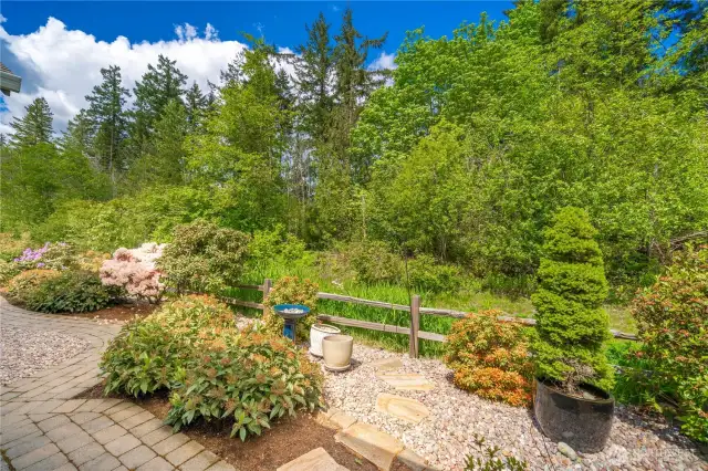 The HOA maintains the property behind the split rail fence and should bloom shortly!  A buyer could replace the split rail fencing with an HOA approval.