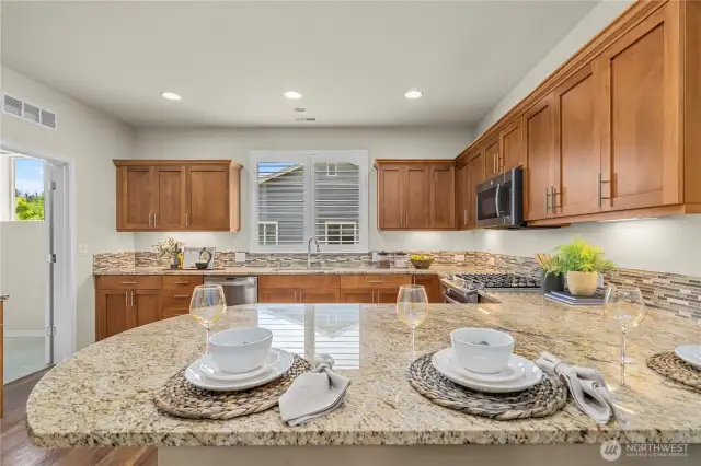 These counters and cabinets are timeless and sleek.  Top tier appliances and under cabinet lighting.