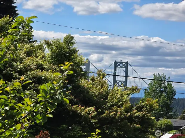 VIEW of the Narrows Bridge from the back deck and wall of windows in the living room.