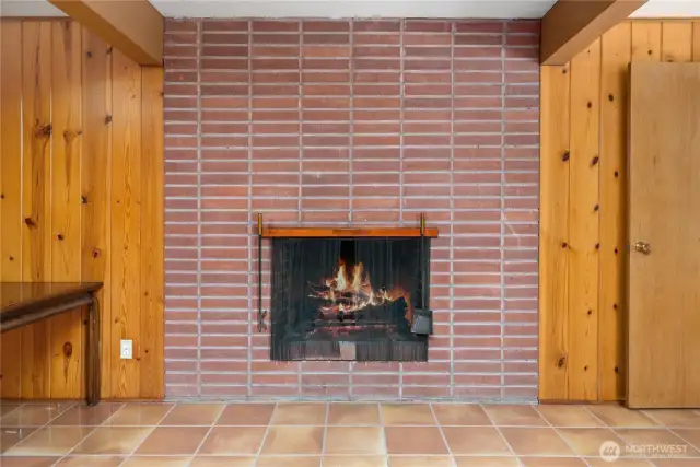 Another wood-burning fireplace with classic brick surround.
