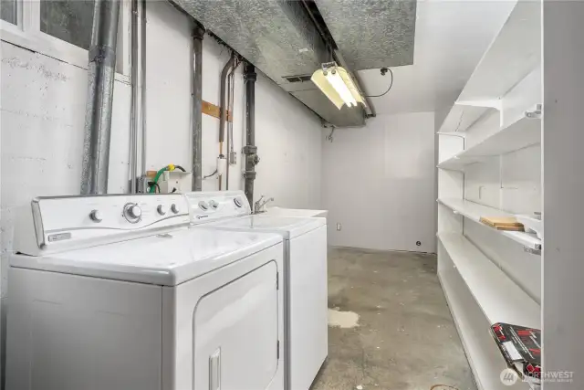 Large utility room with plenty of storage space is located at the bottom of the stairs.