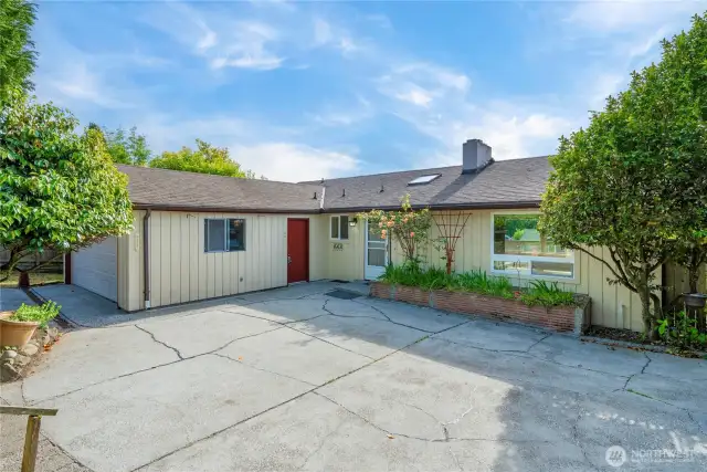 HUGE patio off the front of the home is surrounded by mature landscaping and very private. What would you do with this space?