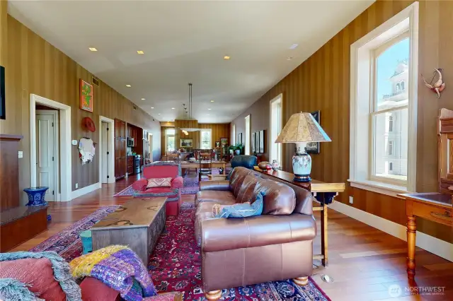 Open concept living spaces with natural flow between lounge, dining and kitchen areas, enhanced by tall windows and abundant natural light
