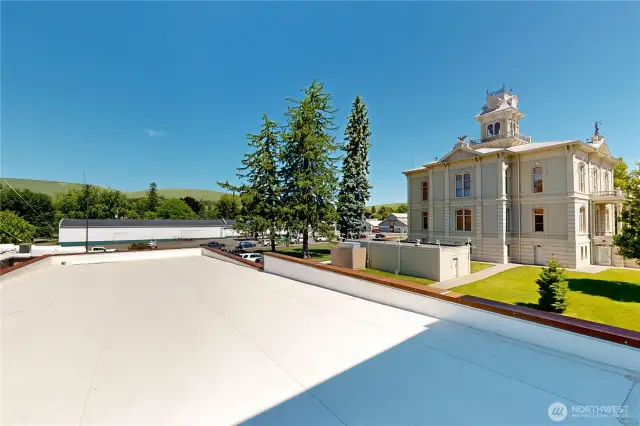 Rooftop views stretch across the historic courthouse and the rolling hills beyond—an ideal spot to pause, reflect, or simply take it all in.