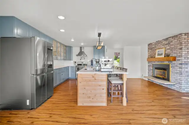 The eat in kitchen is on the right side upon entry with the gas fireplace