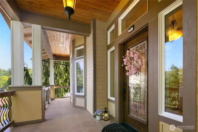 A covered front tiled porch captures a soothing territorial view.