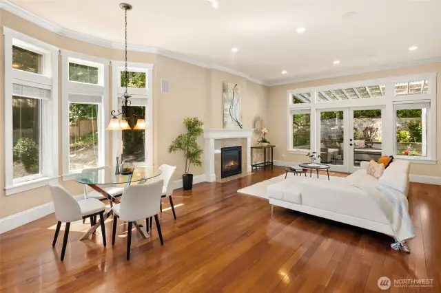 Dream kitchen boasts high-end appliances, including a Bosch refrigerator and dishwasher. Features include a stylish tiled backsplash, glass pantry door, spacious central island with cabinetry, slab granite countertops, and an elegant breakfast nook that flows from the family room to the outdoor retreat. Abundant natural light completes the space.