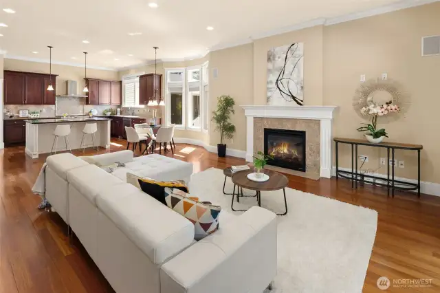 The oversized family room features a gas fireplace and opens to an expansive covered Trex deck for a seamless indoor-outdoor retreat.