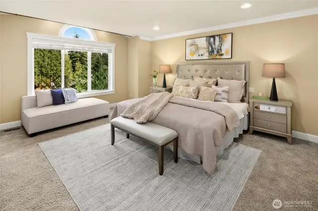 Master suite with spa bath features an extra-large jetted tub and tiled  shower, heated travertine floor, two skylights, two walk-in closets, and soothing territorial views through picture windows.