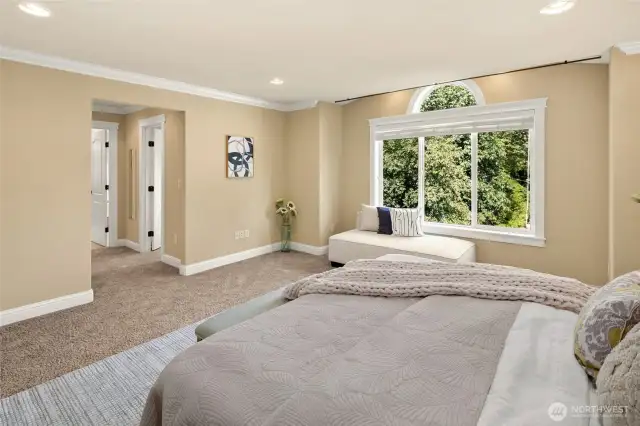 Master suite with spa bath features an extra-large jetted tub and tiled  shower, heated travertine floor, two skylights, two walk-in closets, and soothing territorial views through picture windows.
