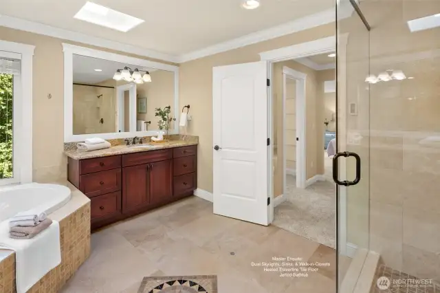 Luxurious master spa bath features an extra-large jetted tub and tiled  shower, heated travertine floor, two skylights.