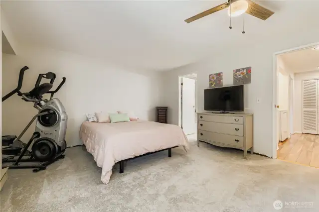 Large primary bedroom with newer carpet, dual closets and attached full bathroom.