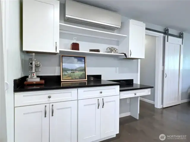 Mini-split for heat/AC. Door leads to primary bedroom and utility room.