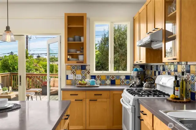 Cheery & Vibrant kitchen connects right out to large back deck and to an amazing garden beyond.