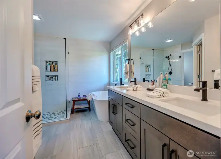 Fully remodeled & spacious primary spa-inspired bath boasts relaxing garden tub, custom shower & XL walk-in closet.