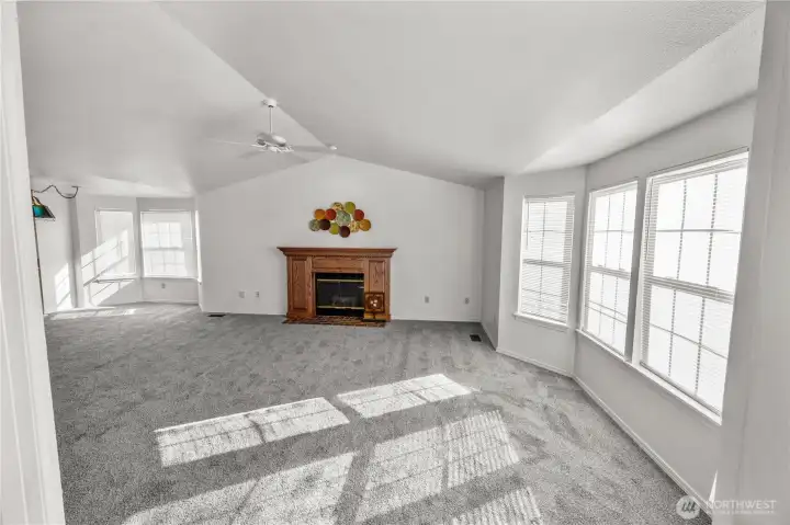 vaulted ceilings always add height to rooms, gas fireplace, bay windows add elegance