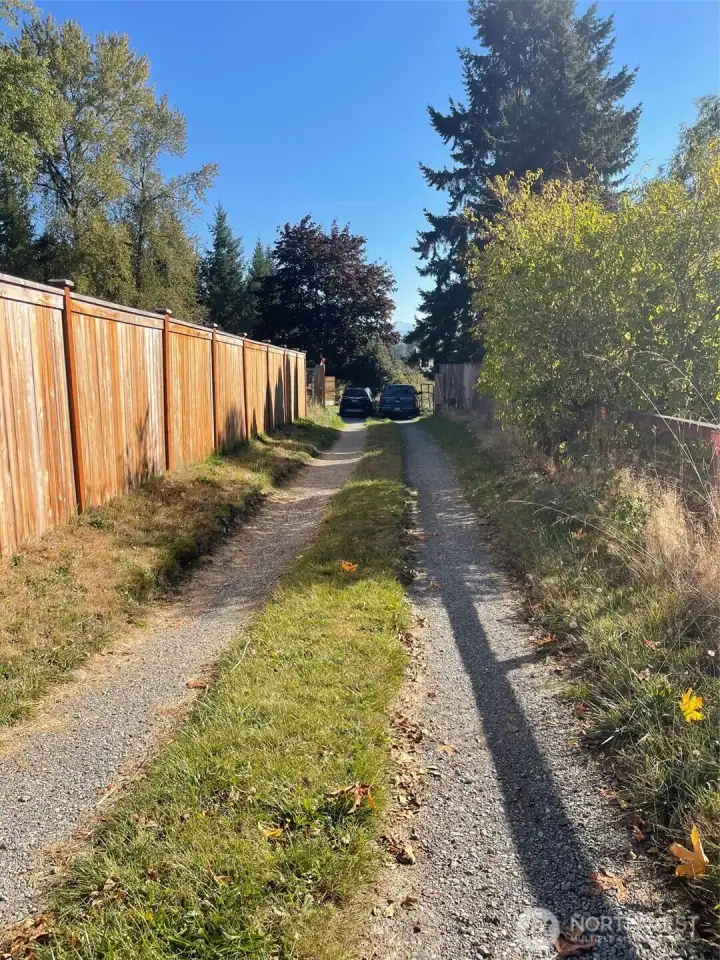 Access Road to properties cuts between two other homes that sit closer to Webster Road.