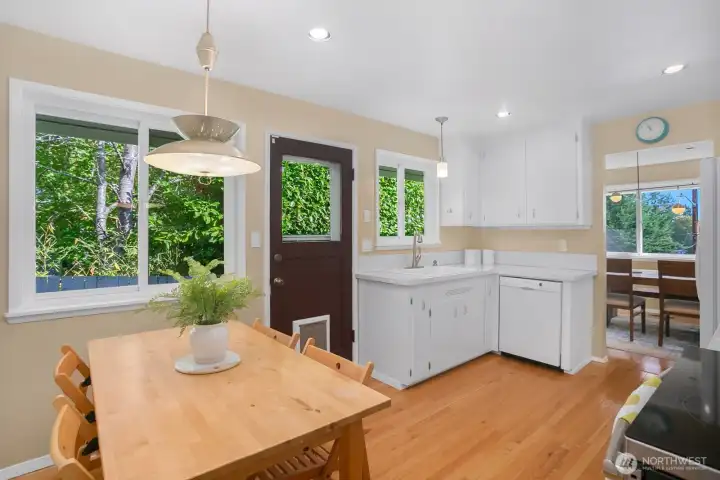 The kitchen has a 2nd eating space and a doorway that goes out the side of the house to get to the backyard.