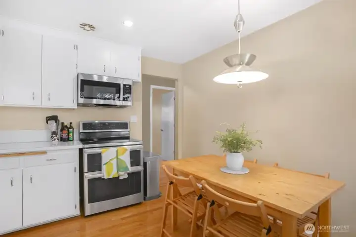 One last view of the kitchen showing the stove with double ovens and the doorway that leads out to the hallway.