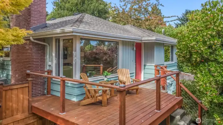 There's a deck on the front of the house that has privacy from trees in the front yard.