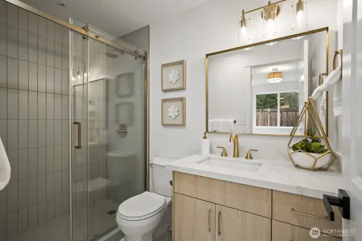 Fully renovated primary bathroom with elegant tiled shower