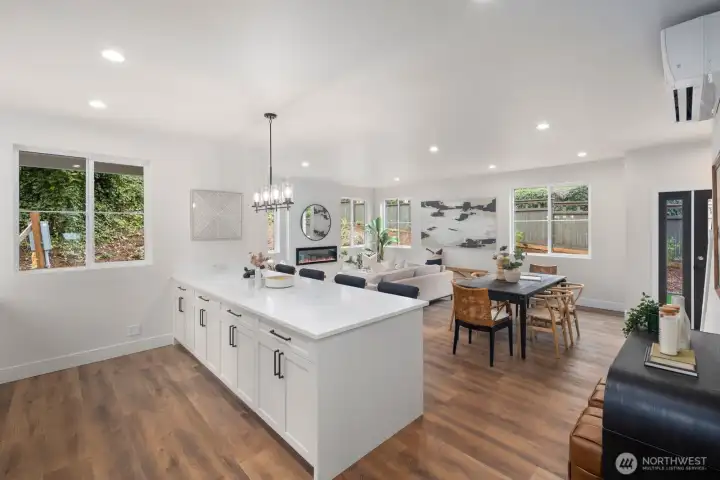 Another view looking out to the living and dining area from the kitchen allows you to see all the windows on this main floor home. Another view looking out to the living and dining area from the kitchen allows you to see all the windows on this main floor home.