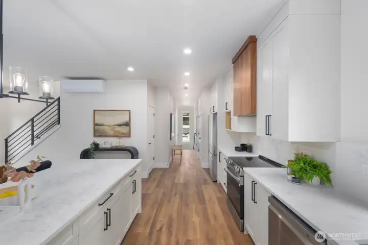 From this view you can see the hallway which leads to the double door pantry on the other side of the fridge, then the powder room and down the stairs a storage area and the door leading to the garage. Opposite the fridge is your coat closet. From this view you can see the hallway which leads to the double door pantry on the other side of the fridge, then the powder room and down the stairs a storage area and the door leading to the garage. Opposite the fridge is your coat closet.