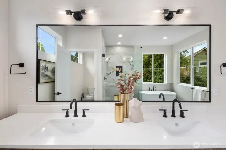 Master bathroom, through the mirror you can see the layout for the toilet area, shower and soaking tub. Master bathroom, through the mirror you can see the layout for the toilet area, shower and soaking tub.