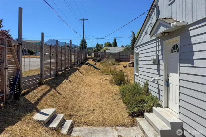 Fully fenced back yard, with a slide.