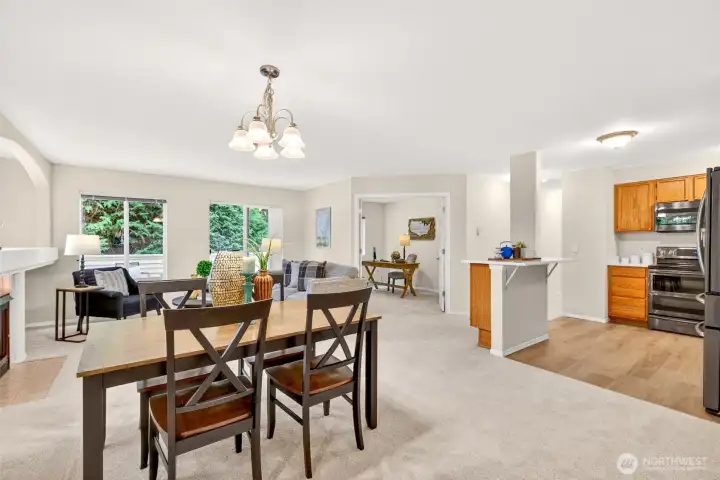 The open-concept main level connects dining, living, and kitchen in one easy flow, ideal for both relaxed evenings and entertaining. Windows pull in soft natural light and leafy outlooks, while the updated kitchen sits within steps of the gathering space.