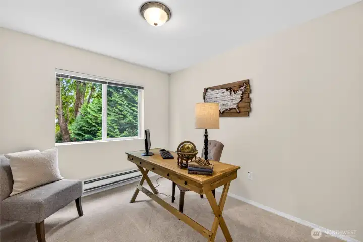 A versatile bedroom with a peaceful, tree-filled outlook adapts easily to a home office, guest room, or hobby space. New carpet and natural light make it a flexible retreat that works for whatever life calls for.