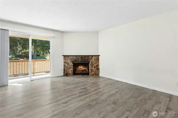 Sun filled living room with cozy wood burning fireplace Sun filled living room with cozy wood burning fireplace