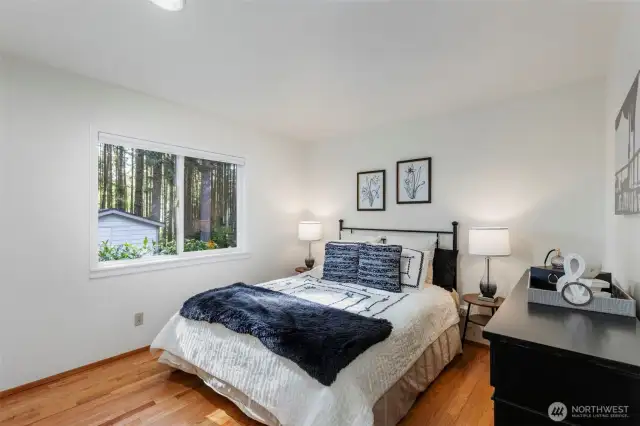 Bedroom #2 of 3. Hardwoods and view of back yard.
