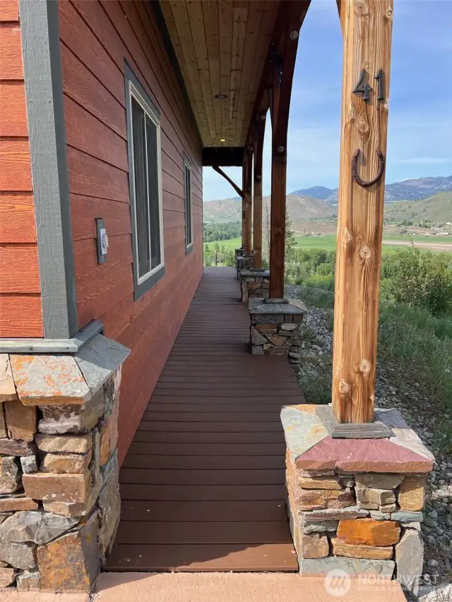 Covered entry with natural wood beams and stone column details, plus Composite decking & walkway with commanding views