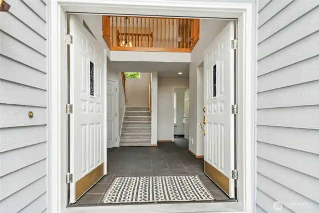 Entrance, Vaulted Ceiling Foyer with access to Living, Family, Dining, Office, and Stairs to Upper Floor.