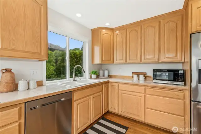 Main Floor Kitchen, with window view of Cherry Blossoms in Spring