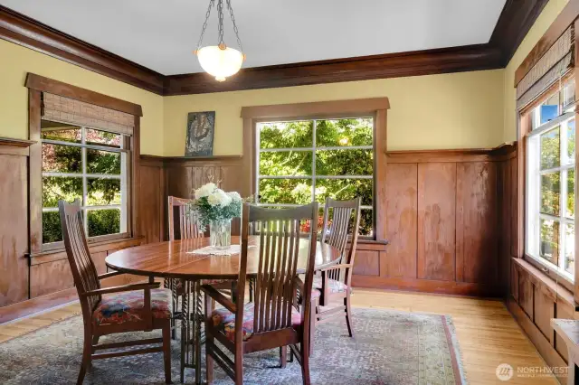 True formal dining room with wainscotting and plate rail.