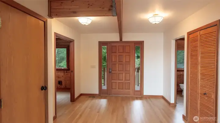 To the left is the Den, right a powder room, door on the left to the full finished basement