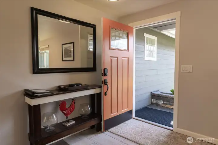 Entry with a beautiful vibrant orange front door