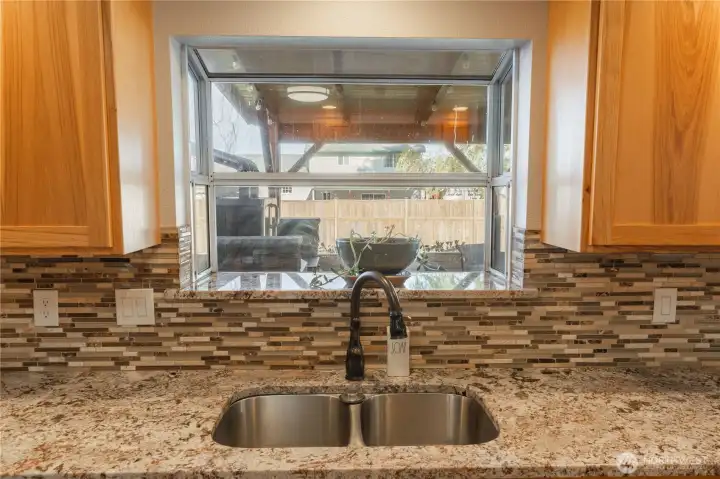 Garden window in the kitchen, over looking the fenced back yard