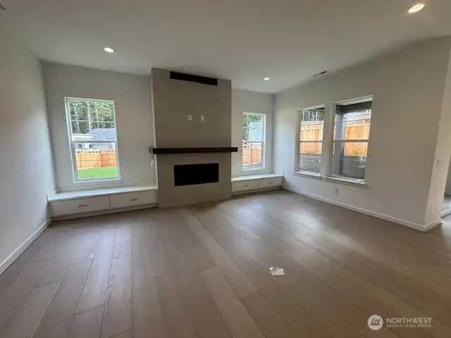 Beautiful great room with natural light, tiled fireplace and built in cabinets