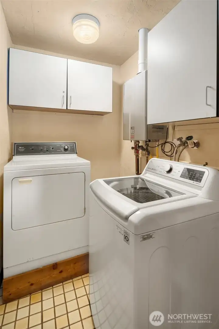 Laundry room with on demand hot water heater off of the family room.