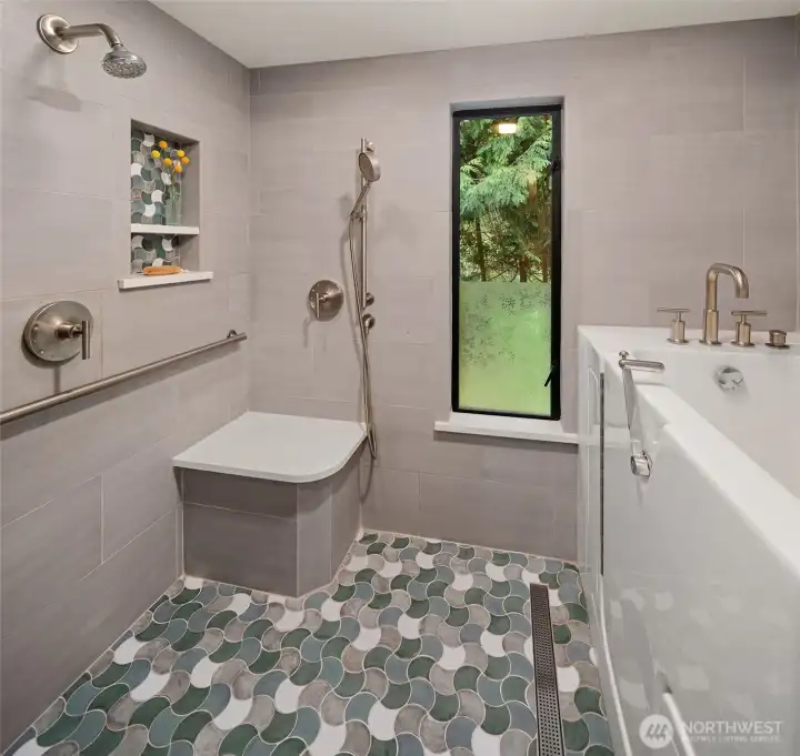 Primary shower with two shower heads and a walk in shower.