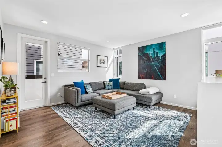 Living room with covered outdoor deck, perfect for grilling.