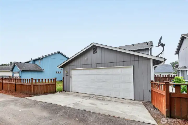 2 Car ATTACHED GARAGE with single door  Workbench / Hanging rod / Storage shelves / Loft storage  2 ceiling heaters / Walls are taped, sheet rocked & painted  Exterior man door / Garage door opener / Rear alley access